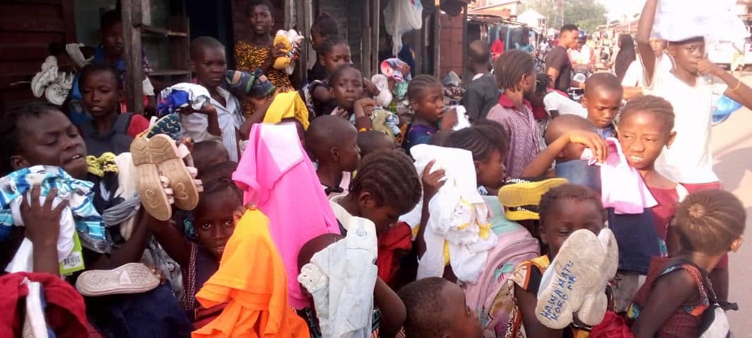 Children receiving donated clothing