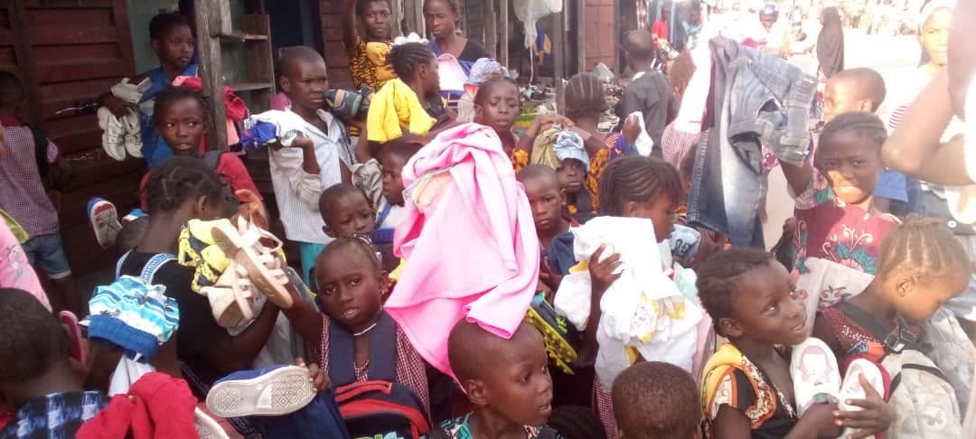 Children gathered with donated clothes
