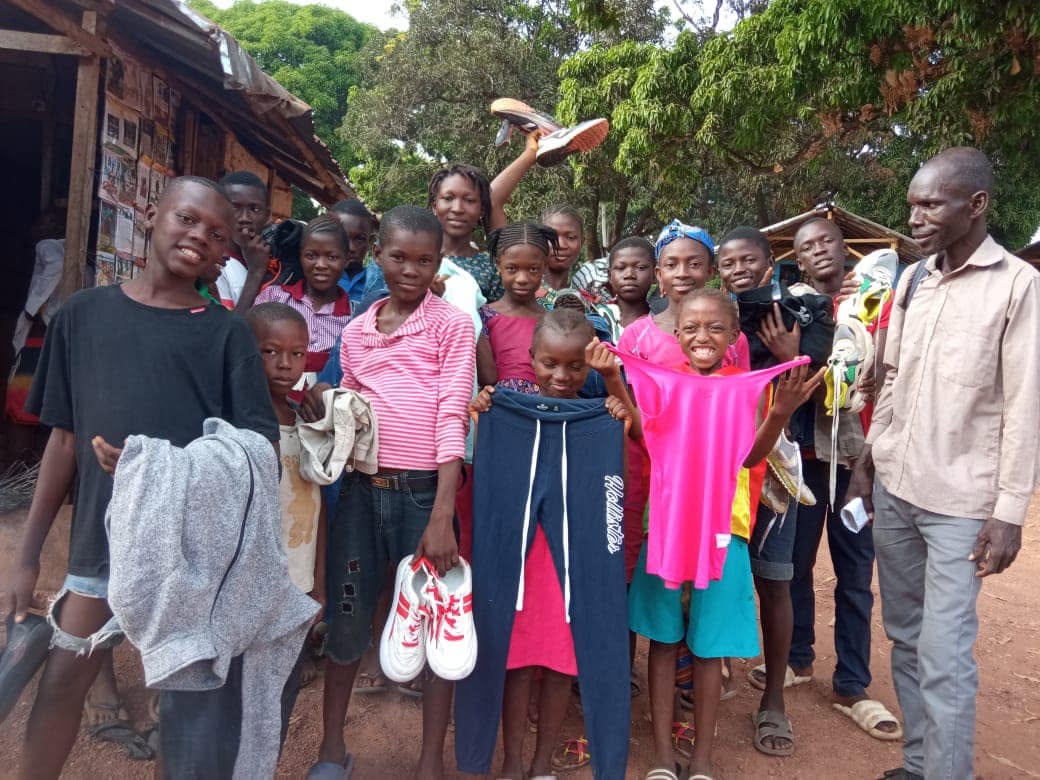 Children displaying clothing and shoes